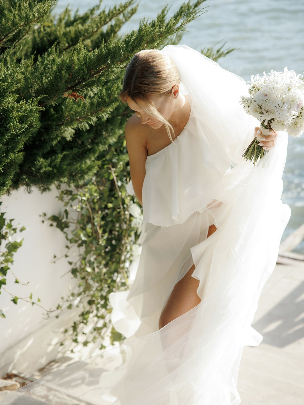 Close-up of bride’s designer heels and dress hem