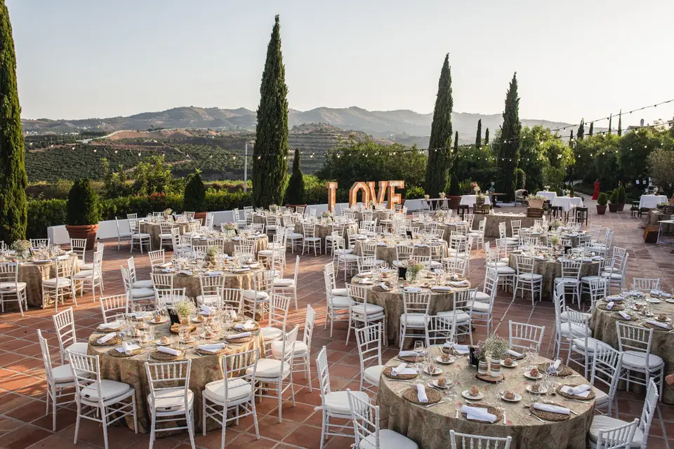 Spain wedding reception with round tables and big letters