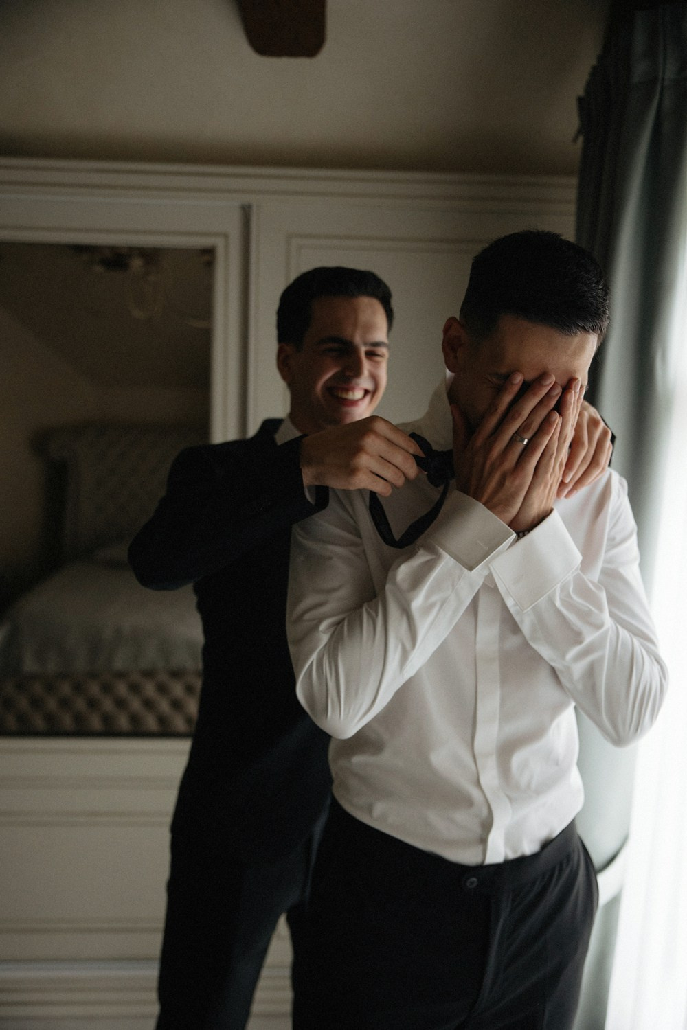 Documentary-style shot of groom getting ready abroad