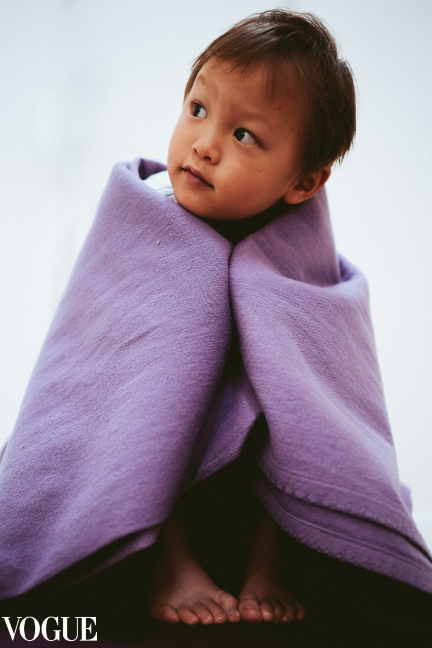 Boy sitting covered in a purple blanket. Kids and family photography at home. Family photography Solihull and Birmingham. Family photographer near Solihull.