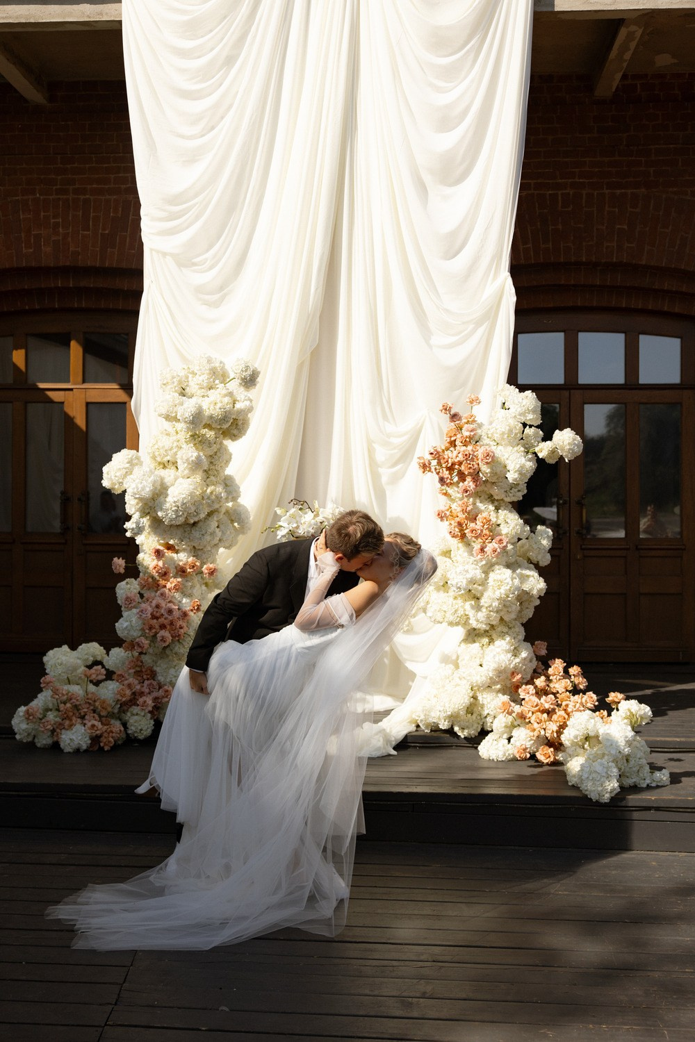 Bride and groom embracing on a London rooftop