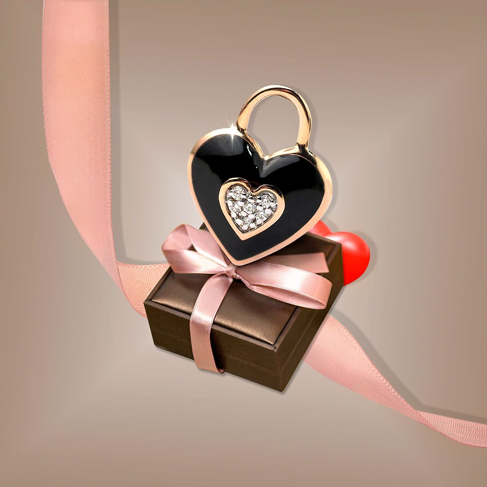 Zlatni privezak srce na pakovanju sa mašnom.