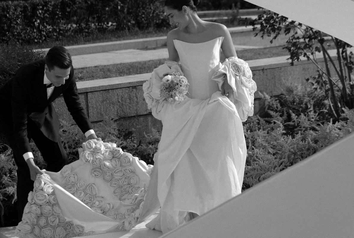 Groom adjusting bride’s veil in quiet moment