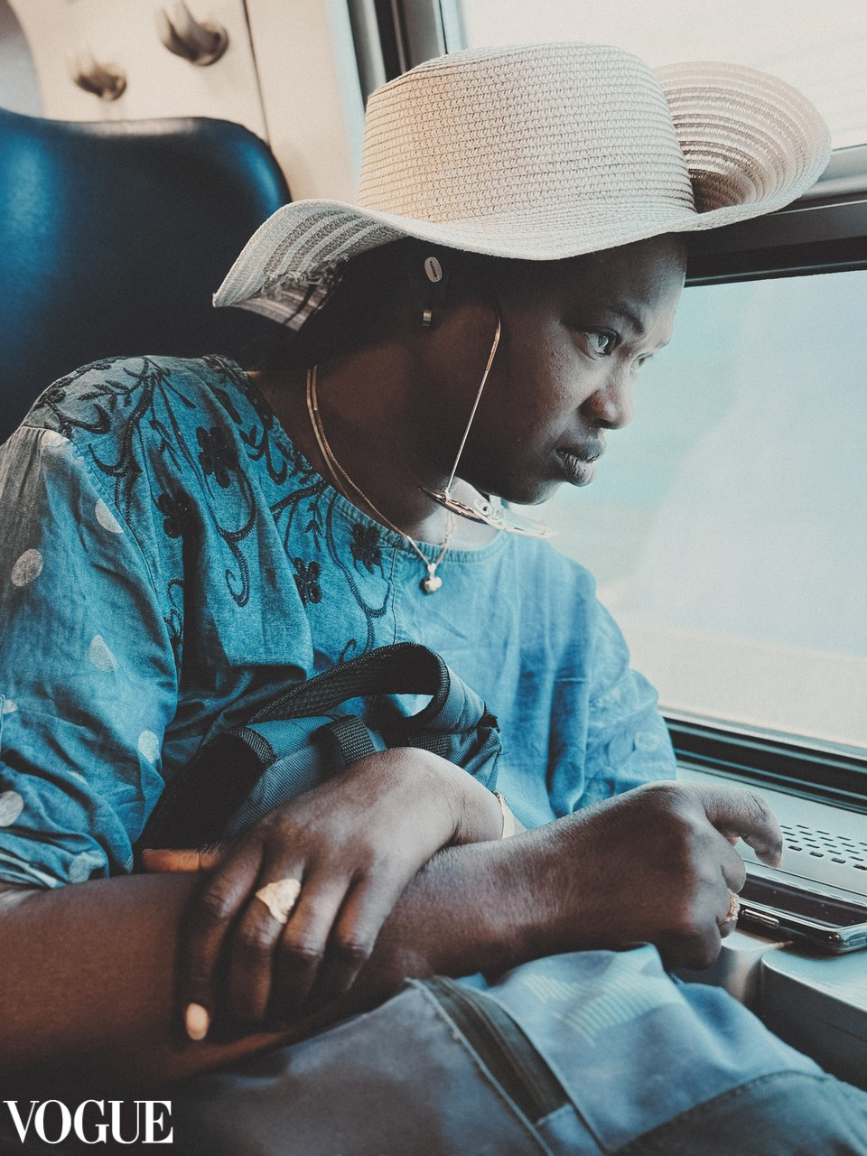 Black lady in the train travelling.