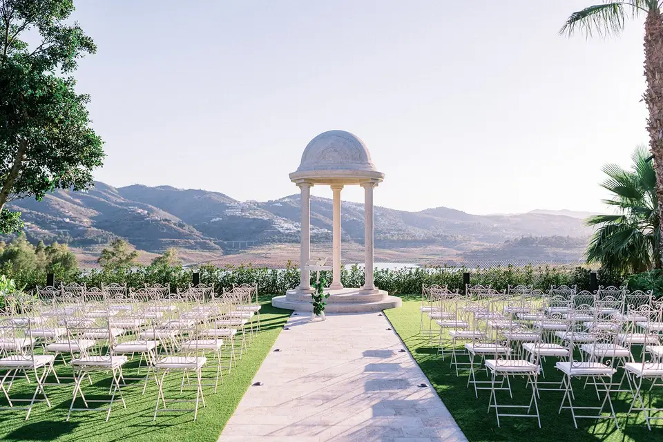 Wedding ceremony with white chairs 