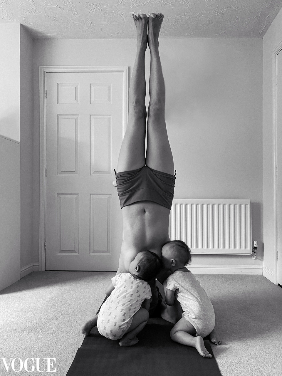 Mum in head-balance feeding twins photography in VOGUE by Irina Zoteeva. Twins photographer, kids photographer, yoga brand photographer Solihull. Solihull Family Photographer. A maternity photographer near me. Newborn lifestyle home photography. Newborn photography near me.