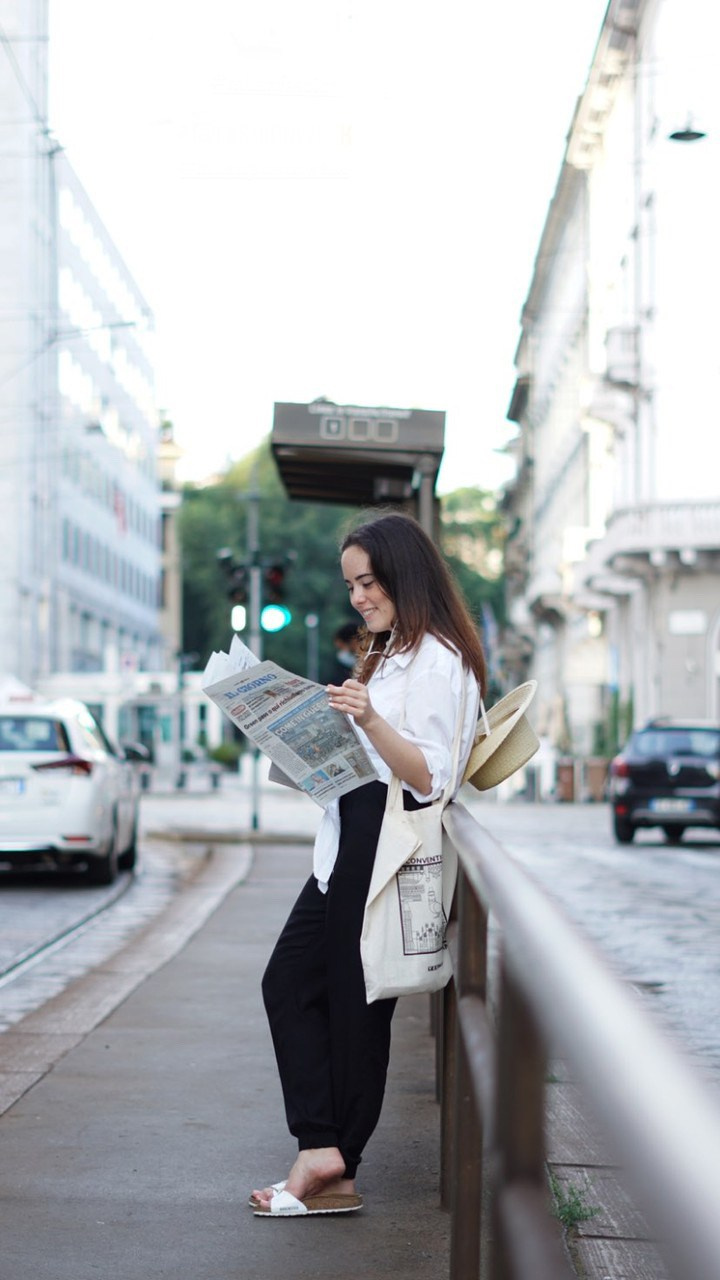 Giovane donna che passeggia per le strade animate della città durante il giorno.
