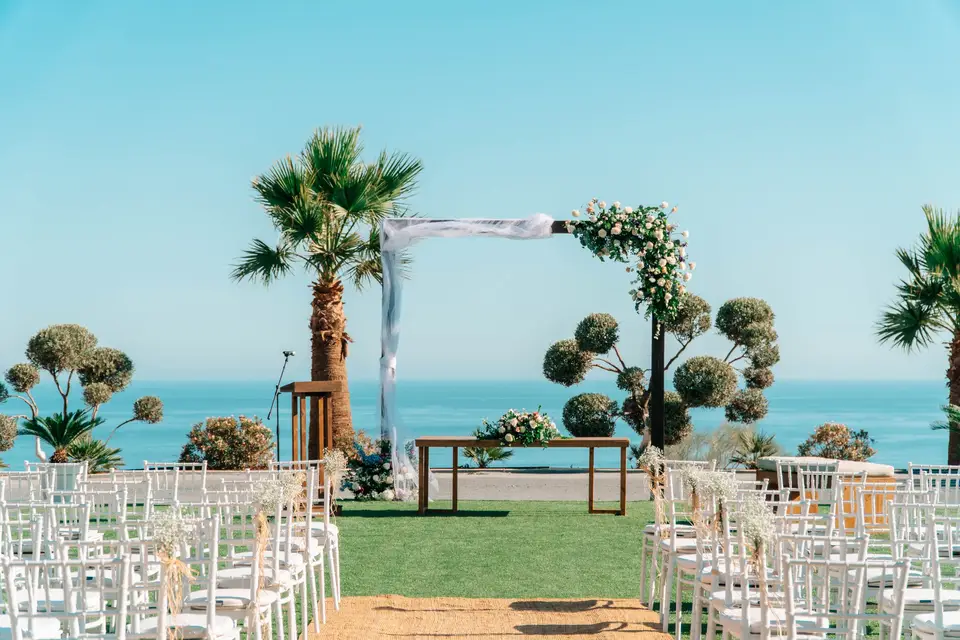 Sea view ceremony arch and chairs