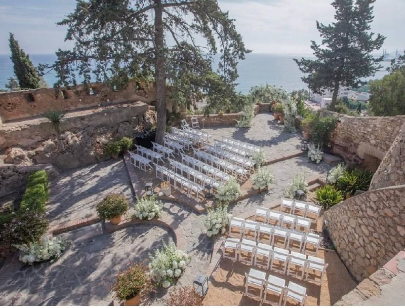 Wedding ceremony white chairs arch and decoration with a sea view