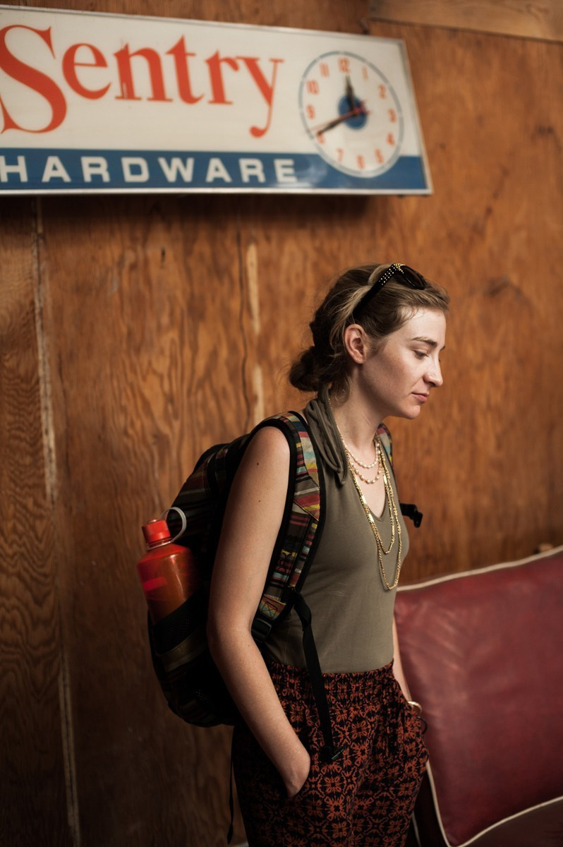 The young lady in a café with a vintage inscription in the background.