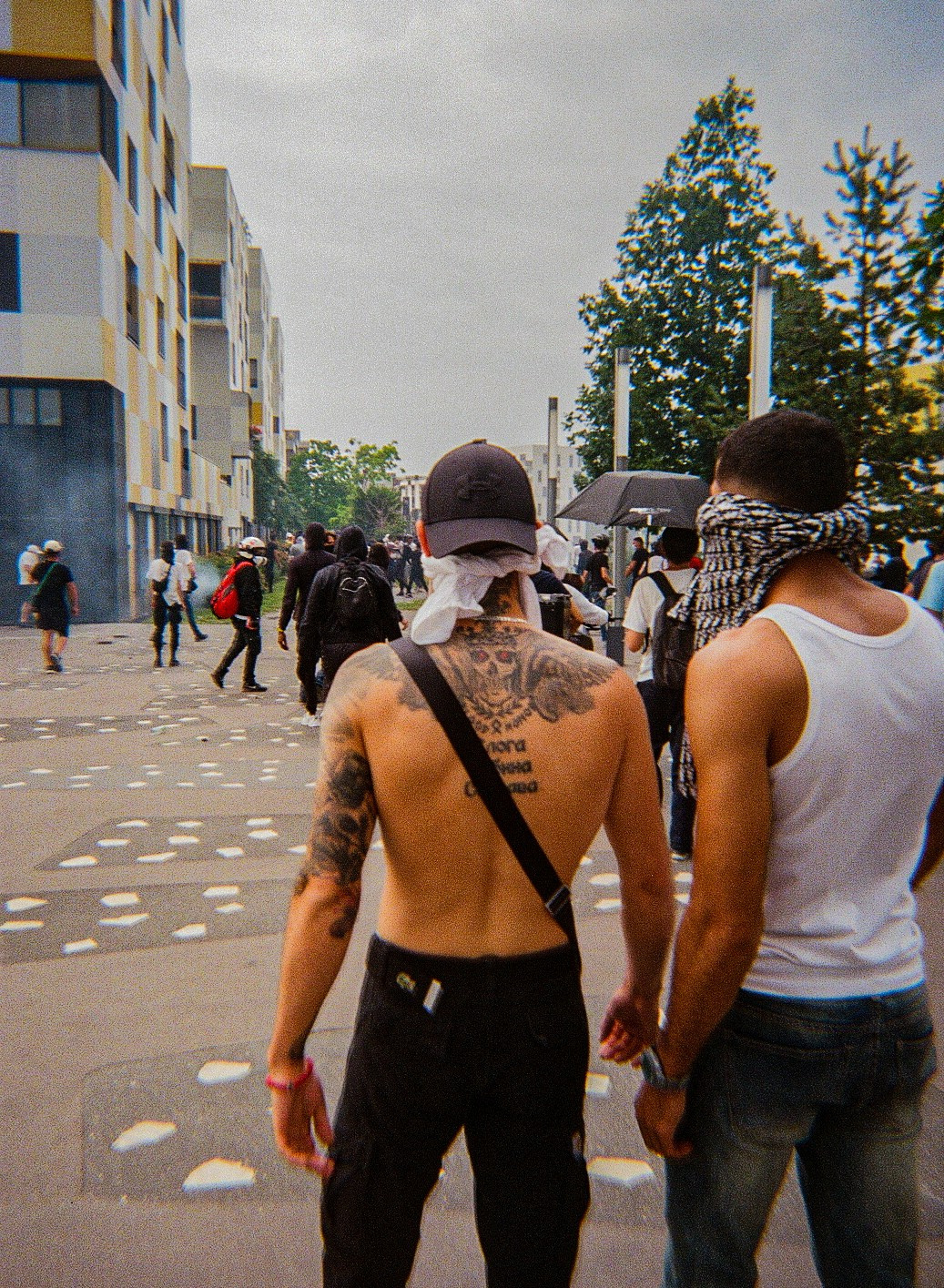 Des jeunes manifestants à Nanterre utilisent des t-shirts ou des foulards pour se protéger des gaz lacrymogènes, permettant de réduire leur inhalation.