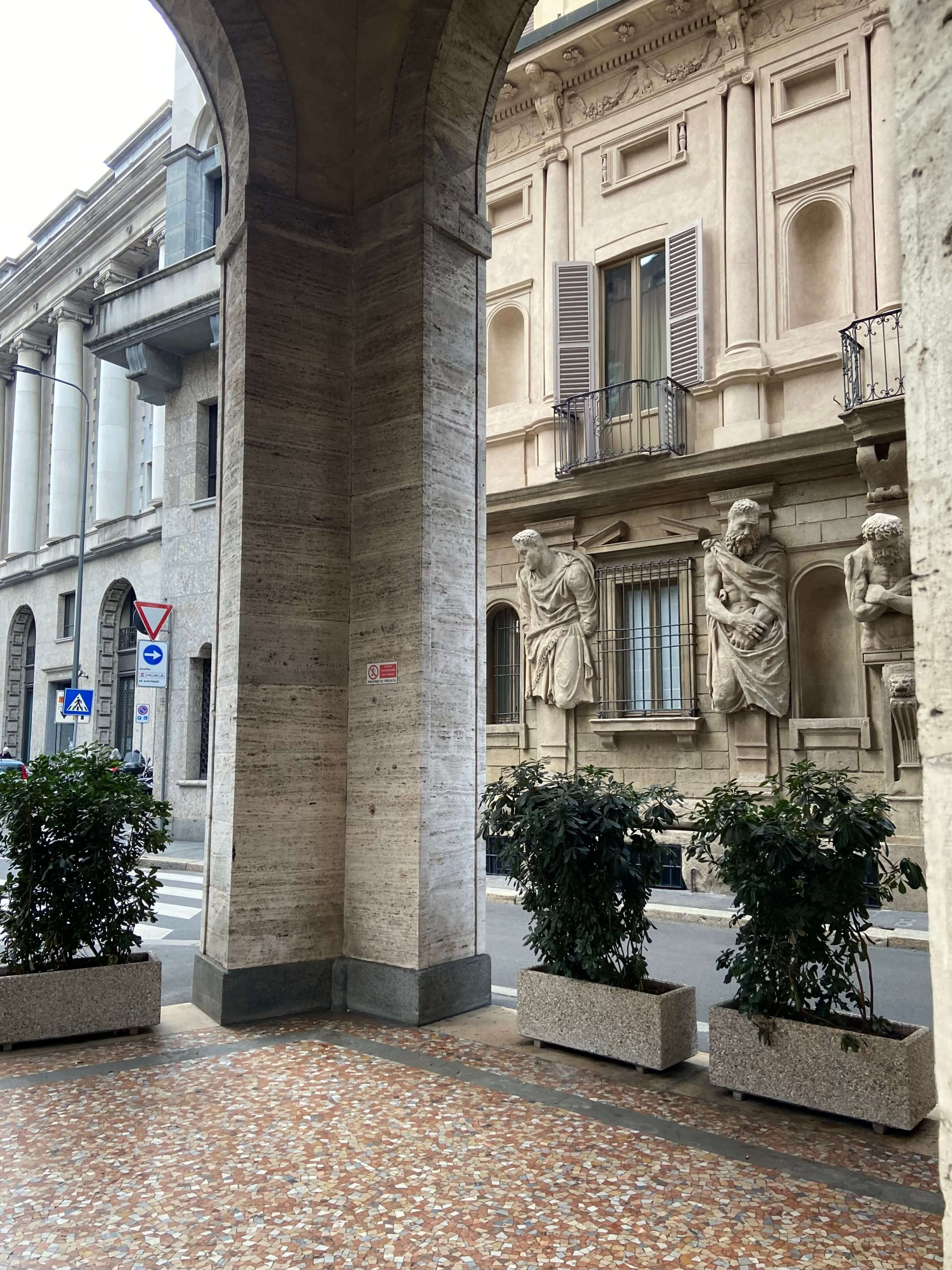 Elegant Milanese building facade with classical sculptures, part of the fashion shoot location route