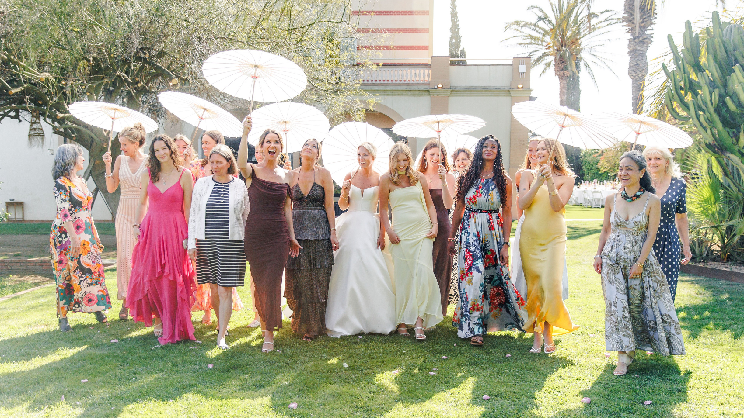 Happy bride surrounded by her friends walking down the backyard of Gran Villa Rosa