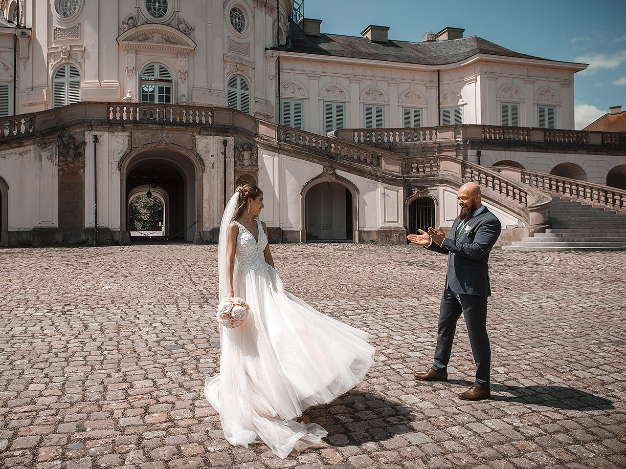 Hochzeitsfotograf bei Schloss Solitude in Stuttgart - Ein glückliches Paar posiert vor der malerischen Kulisse des historischen Schlosses, während der Fotograf ihre besonderen Momente festhält.