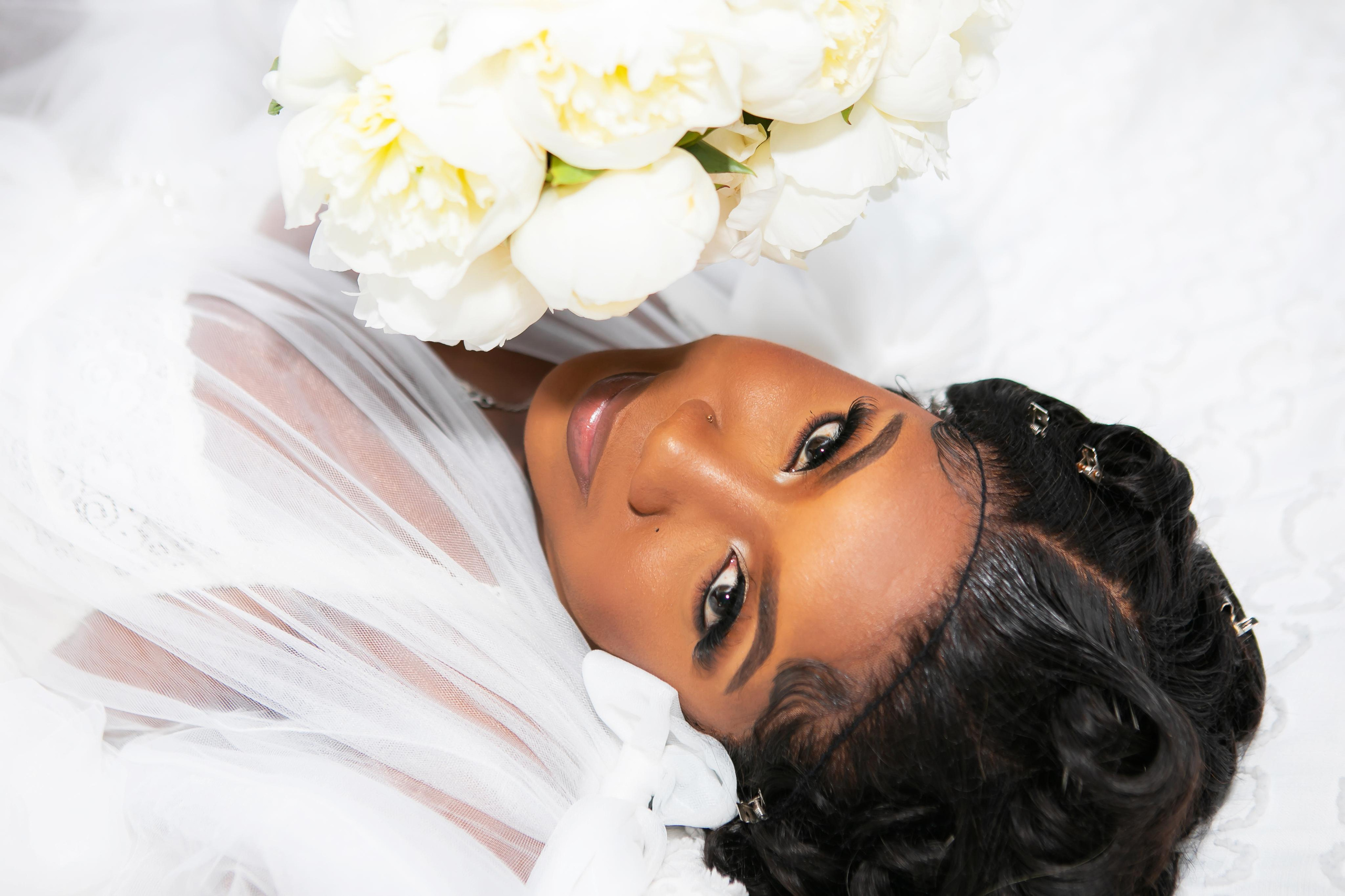 portrait of a bride with a bouquet of white peonies