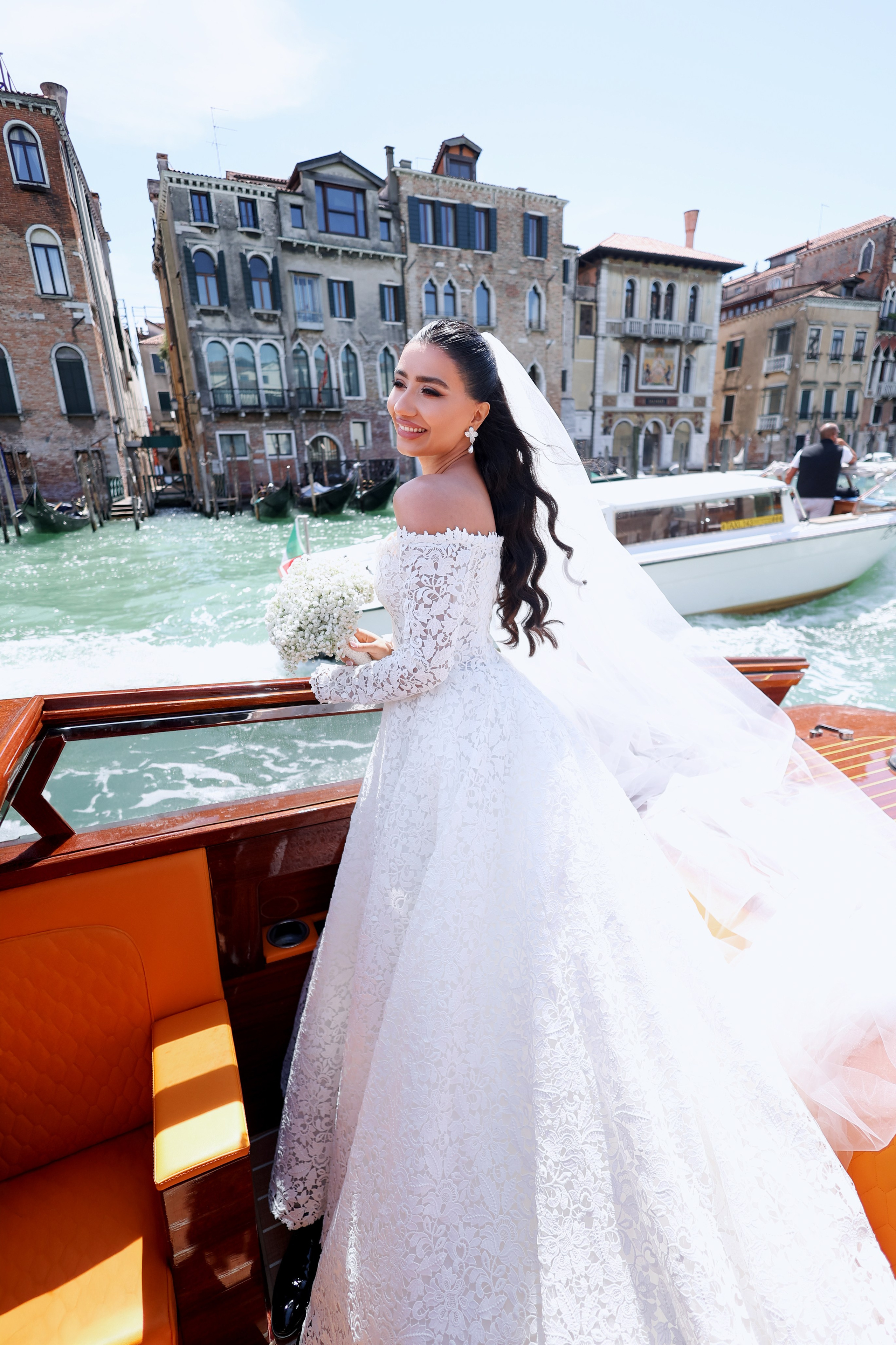Bride arriving at Aman Venice in a classic luxury water taxi