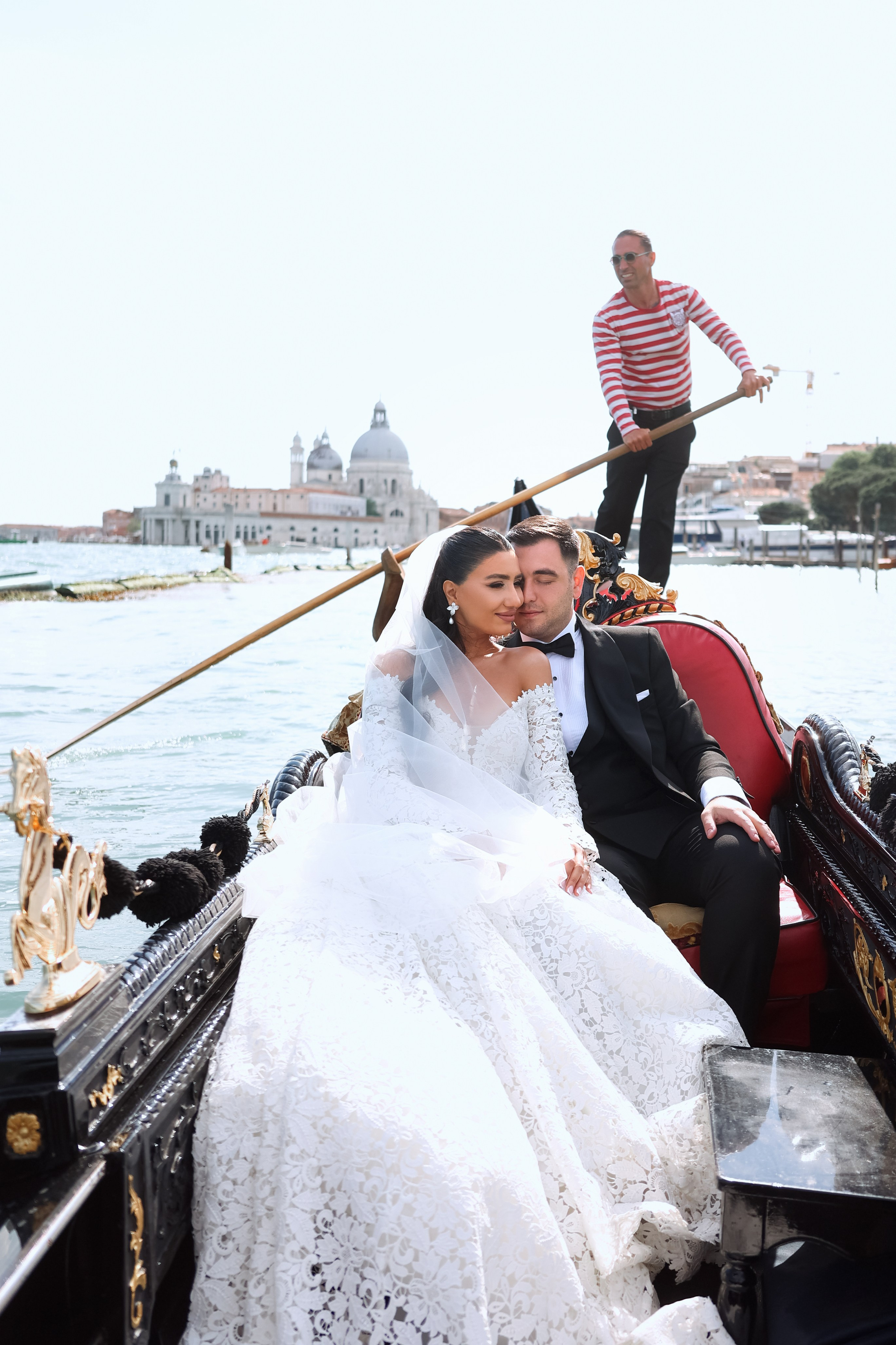 Bride and groom enjoying a romantic gondola ride through the canals of Venice