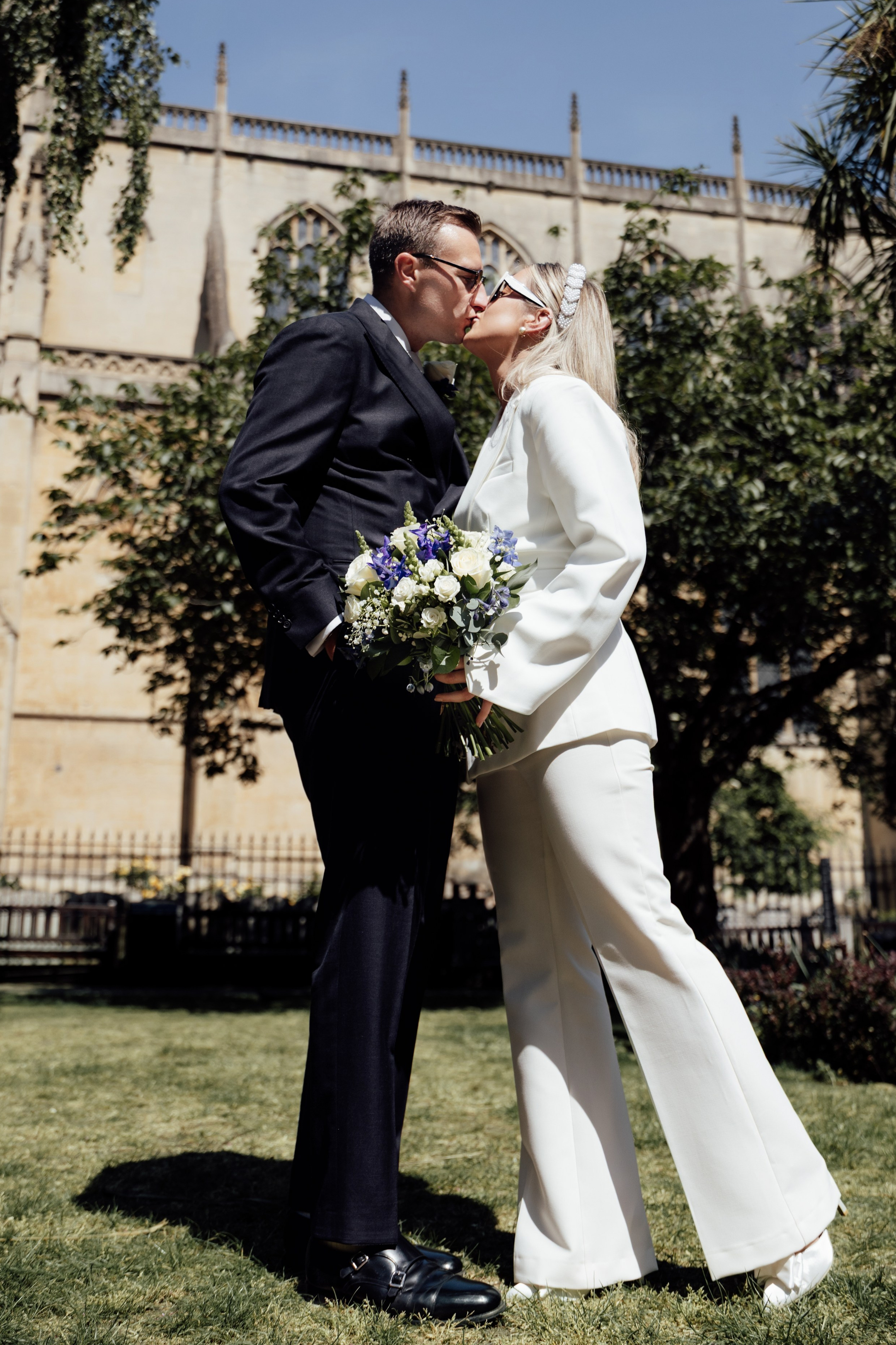 Modern bride and groom in London streets near Marylebone Town HallCandid editorial moment of couple laughing outside Home House wedding venueStylish couple on London steps – timeless black and white wedding portrait