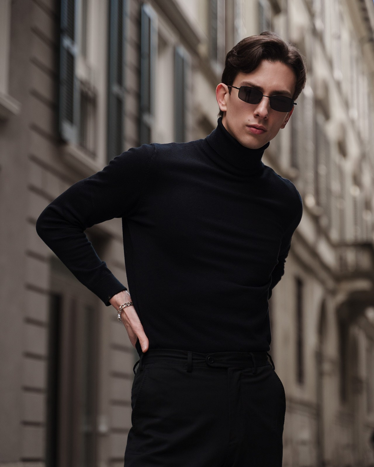 Male model in black turtleneck wearing sunglasses in Milan street