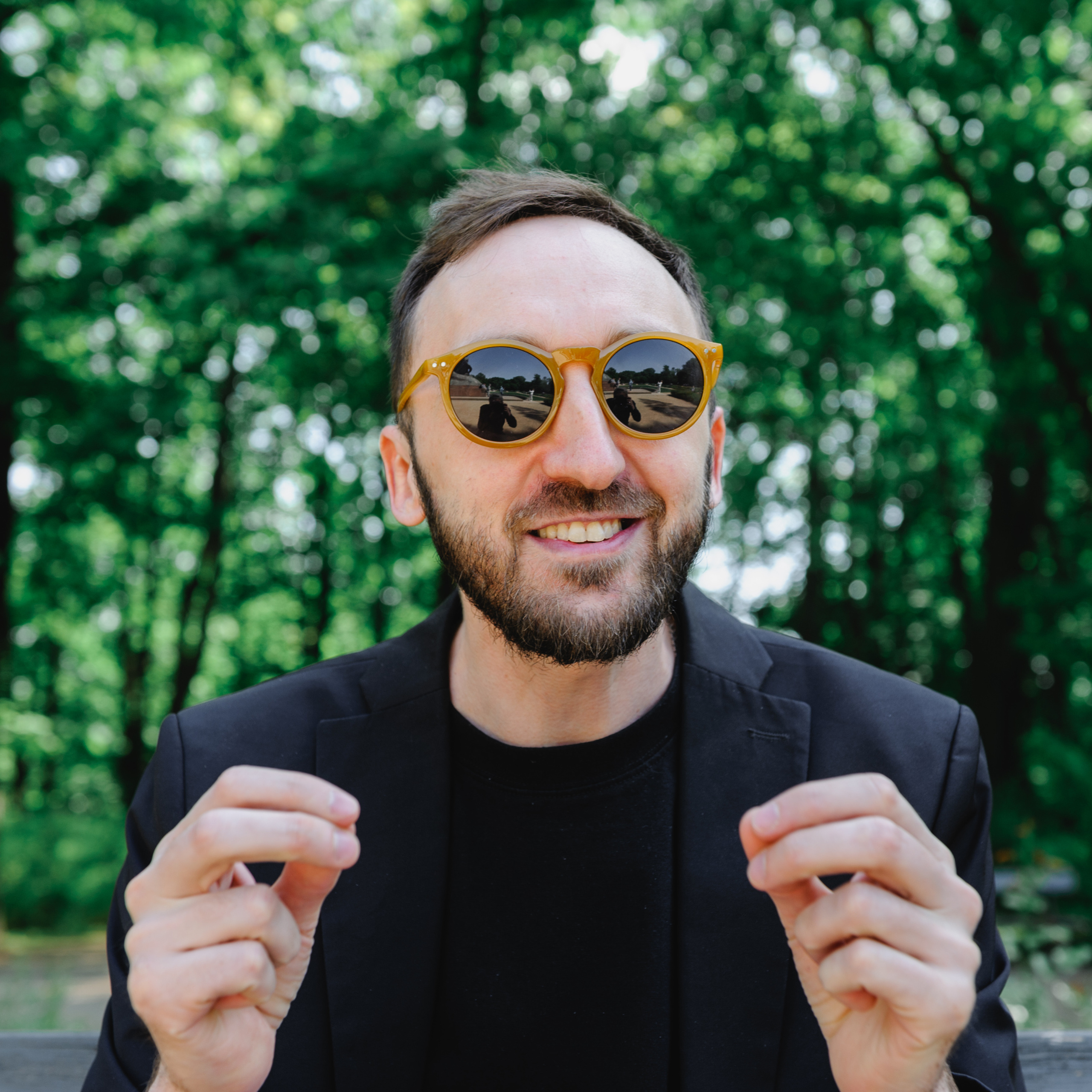 Cultural scholar Dmitry Solodkiy, joyful in sunglasses.