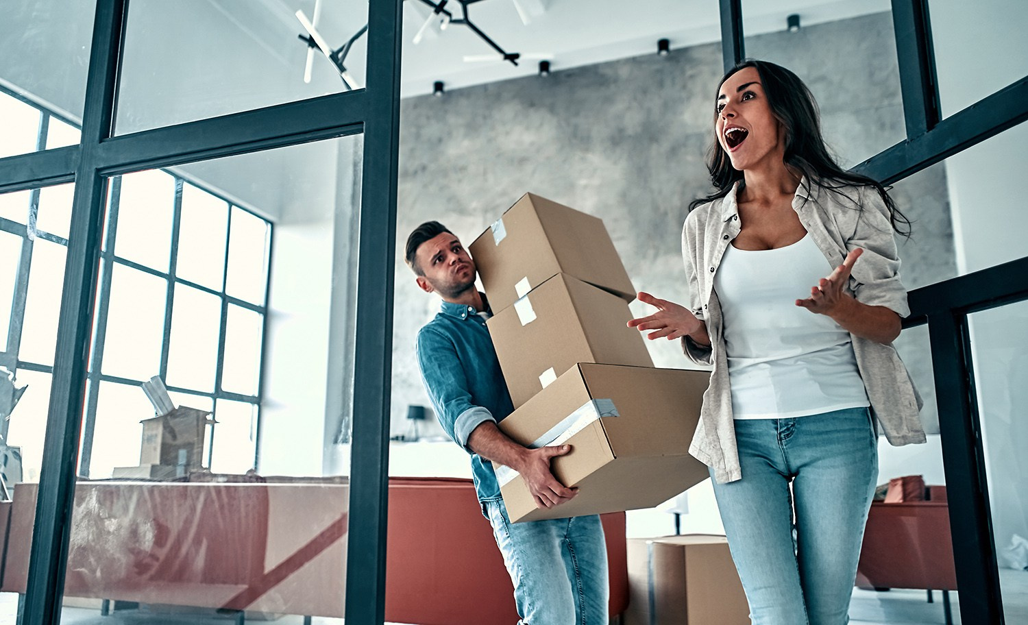 Happy couple moving into their beautifully renovated Athens apartment, showcasing the joyful outcome of a property transformation.