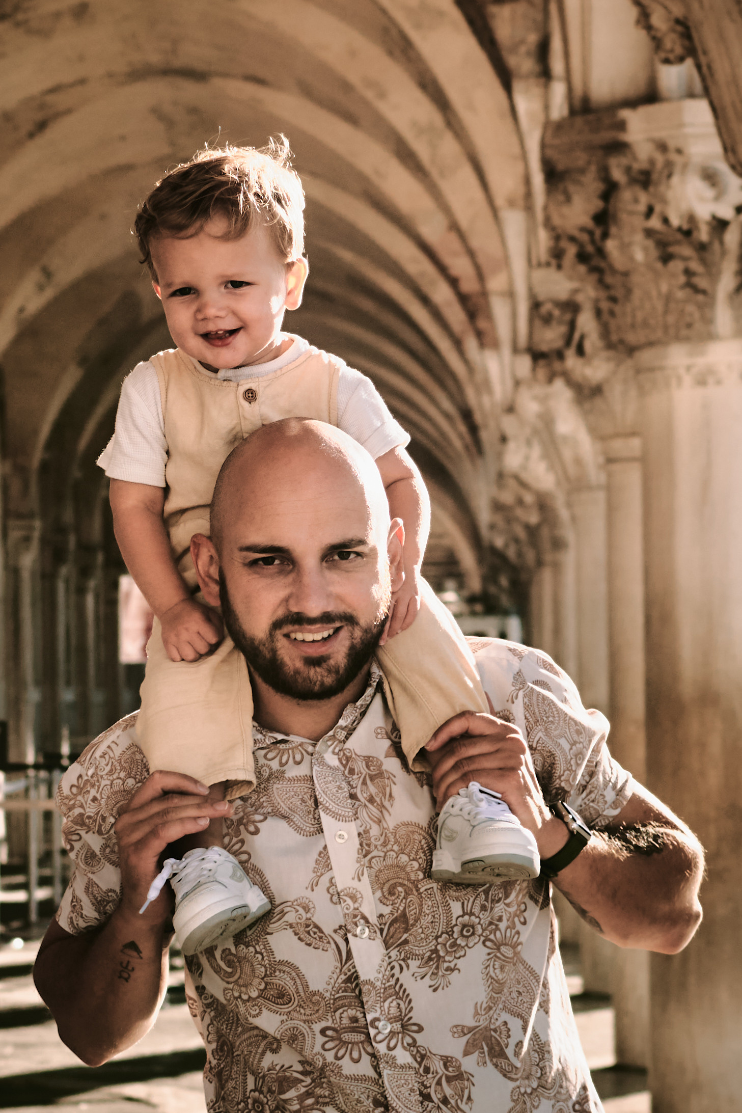 In the heart of Venice, a mother and child share a moment of quiet contemplation on San Marco square. The mother's pregnancy is visible in her gentle curves, while the child's hand rests on her belly, a reminder of the new life growing within. The city's beauty is reflected in their peaceful expressions. A dad and his little one stand in awe of the stunning architecture of San Marco Square in Venice, Italy. Against the backdrop of San Marco Square, a dad and his child share a moment of joy and wonder in Venice.