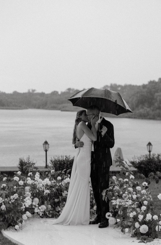 Couple holding hands at sunset in Santorini